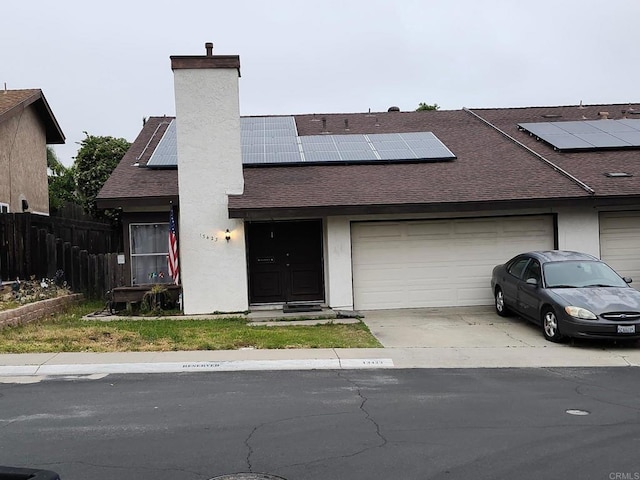 13423 Sutter Mill Rd, Poway, CA 92064 - view of front of house featuring roof with shingles, concrete driveway, a garage, solar panels, and fence