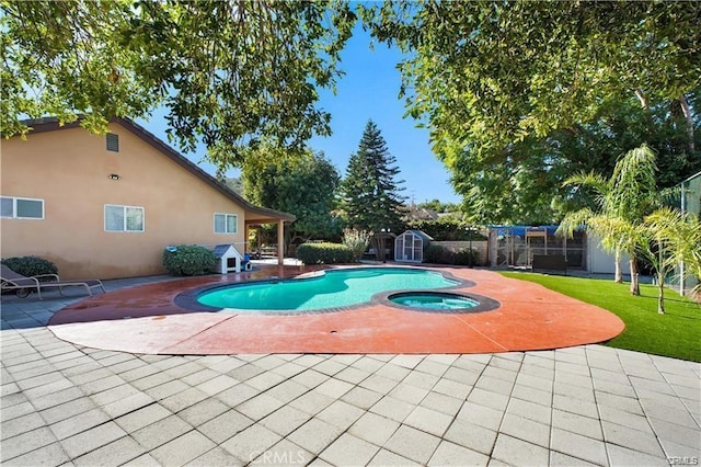 22329 Plummer St, Chatsworth, CA 91311 - view of pool featuring a storage shed, a patio area, an outdoor structure, and an in-ground hot tub