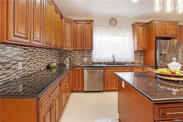 22329 Plummer St, Chatsworth, CA 91311 - kitchen with appliances with stainless steel finishes, a sink, brown cabinets, and backsplash