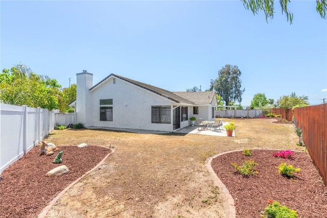 30872 Kiowa River Ct, Temecula, CA 92591 - rear view of property featuring stucco siding, a patio area, and a chimney