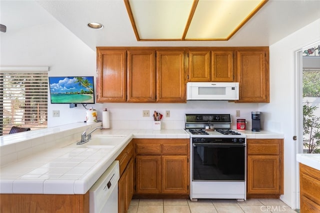 30872 Kiowa River Ct, Temecula, CA 92591 - kitchen featuring white appliances, brown cabinetry, a sink, light tile patterned floors, and recessed lighting