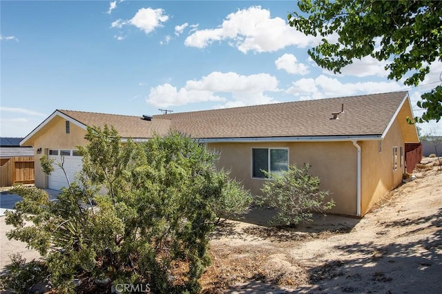 6649 Pine Spring Ave Unit 29, Palms, CA 92277 - ranch-style house with stucco siding, a garage, and roof with shingles