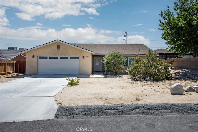 6649 Pine Spring Ave Unit 29, Palms, CA 92277 - ranch-style home featuring a garage, stucco siding, and driveway