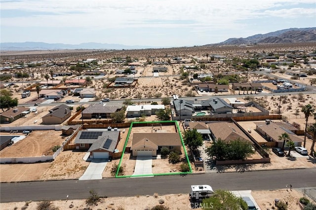 6649 Pine Spring Ave Unit 29, Palms, CA 92277 - aerial view of residential area with a mountainous background, property parcel outlined, and a desert landscape