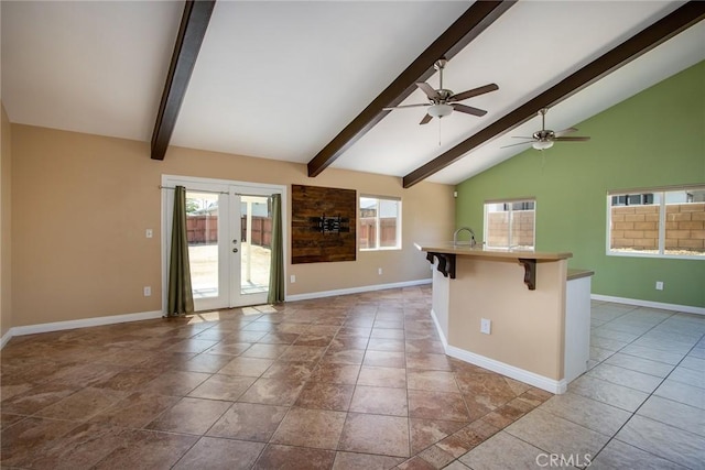 6649 Pine Spring Ave Unit 29, Palms, CA 92277 - unfurnished living room with baseboards, healthy amount of natural light, and french doors