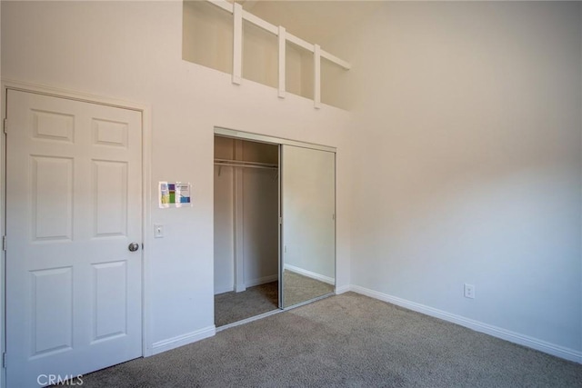 6649 Pine Spring Ave Unit 29, Palms, CA 92277 - unfurnished bedroom with carpet flooring, a closet, baseboards, and a high ceiling