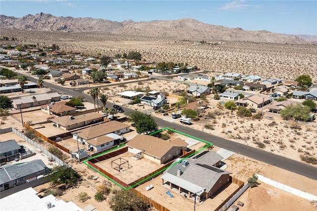 6649 Pine Spring Ave Unit 29, Palms, CA 92277 - aerial perspective of suburban area with property parcel outlined, a mountain backdrop, and a desert landscape
