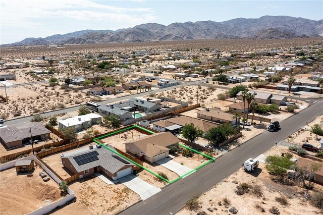 6649 Pine Spring Ave Unit 29, Palms, CA 92277 - aerial view of residential area featuring property parcel outlined, mountains, and a desert landscape
