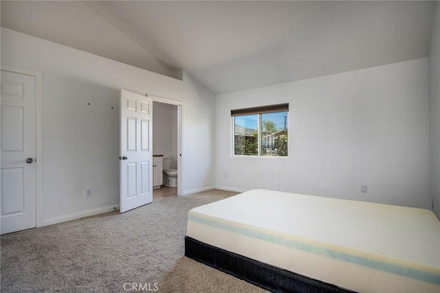 6649 Pine Spring Ave Unit 29, Palms, CA 92277 - carpeted bedroom featuring lofted ceiling, baseboards, and ensuite bath