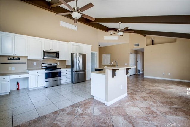 6649 Pine Spring Ave Unit 29, Palms, CA 92277 - kitchen featuring stainless steel appliances, ceiling fan, beam ceiling, high vaulted ceiling, and white cabinetry
