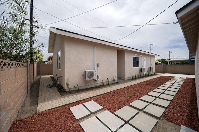 13282-13280 Nevada St, Westminster, CA 92683 - rear view of property featuring stucco siding, ac unit, a fenced backyard, a patio area, and central air condition unit