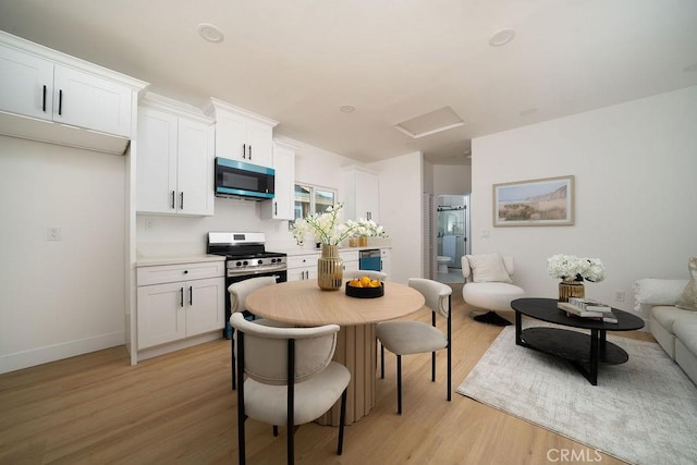 13282-13280 Nevada St, Westminster, CA 92683 - dining space with light wood-style flooring, attic access, and baseboards