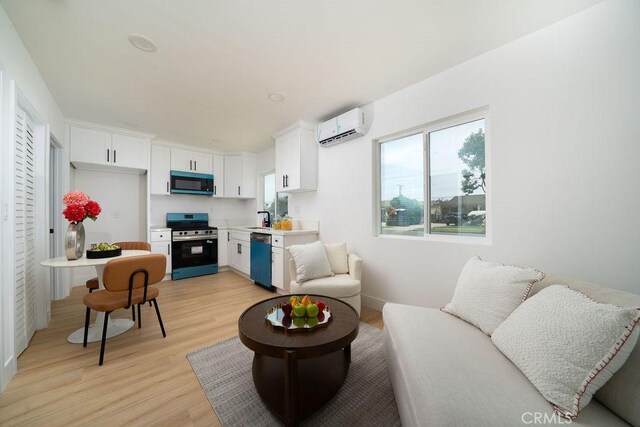 13282-13280 Nevada St, Westminster, CA 92683 - living area featuring a wall unit AC and light wood finished floors