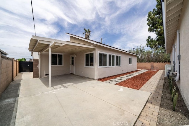 13282-13280 Nevada St, Westminster, CA 92683 - back of house featuring stucco siding, a fenced backyard, a carport, and a patio area