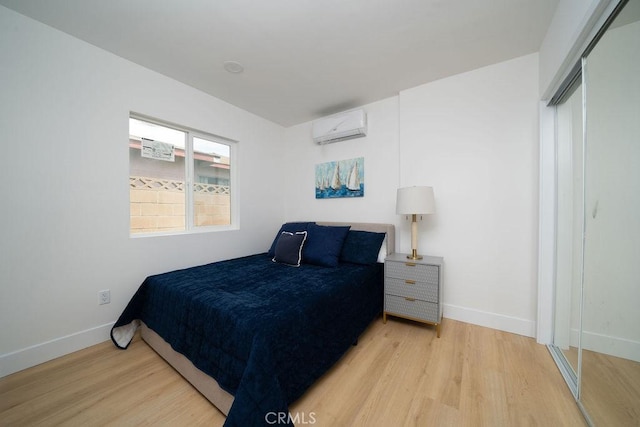 13282-13280 Nevada St, Westminster, CA 92683 - bedroom featuring a wall mounted AC, wood finished floors, baseboards, and a closet