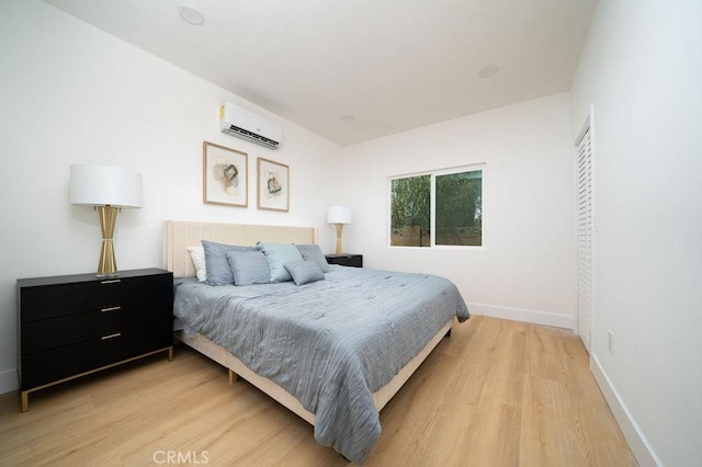 13282-13280 Nevada St, Westminster, CA 92683 - bedroom with a wall unit AC, light wood-style flooring, and baseboards