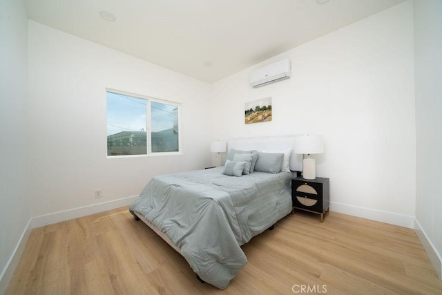 13282-13280 Nevada St, Westminster, CA 92683 - bedroom featuring an AC wall unit, light wood-style floors, and baseboards