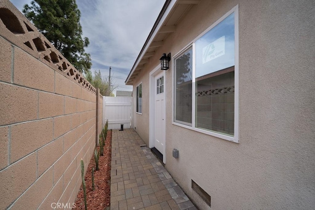 13282-13280 Nevada St, Westminster, CA 92683 - view of side of home with stucco siding, fence, and crawl space