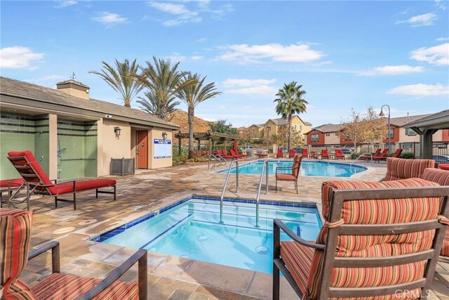 26703 Lexington Ln, Saugus, CA 91350 - view of swimming pool featuring a hot tub, a patio area, and a residential view