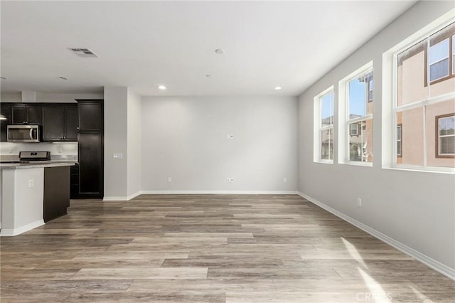 26703 Lexington Ln, Saugus, CA 91350 - kitchen featuring appliances with stainless steel finishes, open floor plan, light countertops, light wood-style floors, and recessed lighting