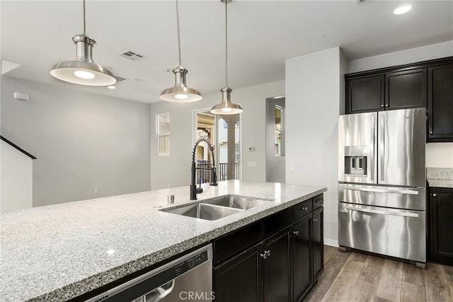 26703 Lexington Ln, Saugus, CA 91350 - kitchen with stainless steel appliances, a sink, light wood-style floors, decorative light fixtures, and recessed lighting