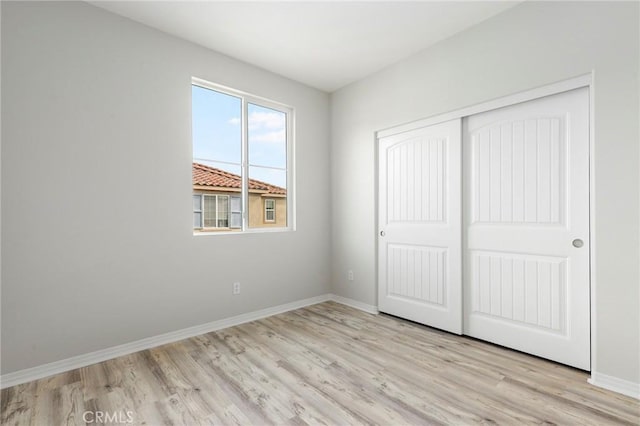 26703 Lexington Ln, Saugus, CA 91350 - unfurnished bedroom with light wood-style flooring, baseboards, and a closet