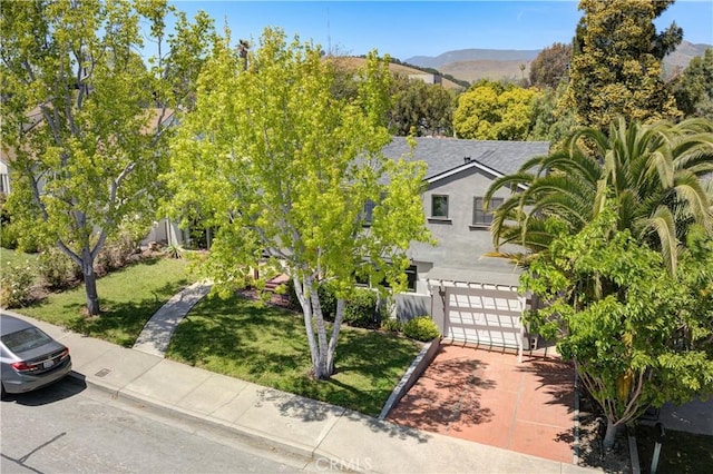 810 Meinecke Ave, San Luis Obispo, CA 93405 - obstructed view of property with an attached garage, a front yard, stucco siding, and concrete driveway