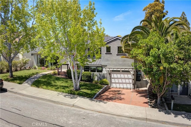 810 Meinecke Ave, San Luis Obispo, CA 93405 - obstructed view of property with stucco siding, a garage, a front lawn, driveway, and a standing seam roof