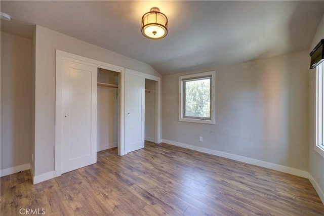 810 Meinecke Ave, San Luis Obispo, CA 93405 - unfurnished bedroom with multiple closets, lofted ceiling, and wood finished floors
