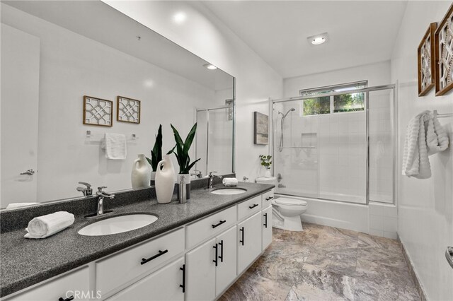 4462 Fallsbrae Rd, Fallbrook, CA 92028 - full bathroom with double vanity, toilet, and combined bath / shower with glass door