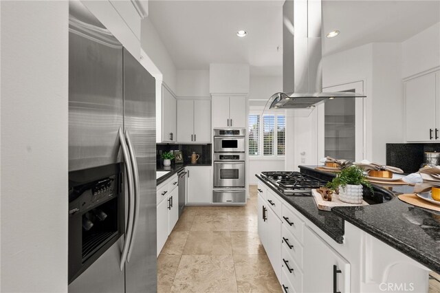 4462 Fallsbrae Rd, Fallbrook, CA 92028 - kitchen with appliances with stainless steel finishes, island range hood, a warming drawer, backsplash, and white cabinetry