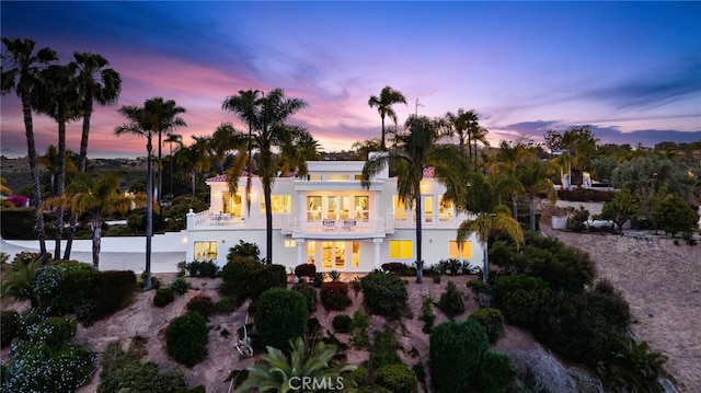 4462 Fallsbrae Rd, Fallbrook, CA 92028 - back of house at dusk featuring a balcony and stucco siding