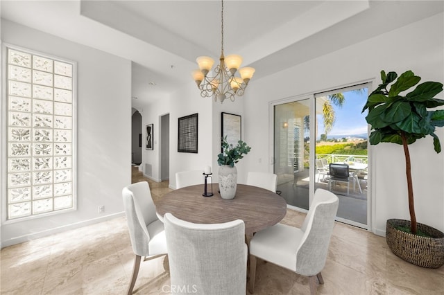 4462 Fallsbrae Rd, Fallbrook, CA 92028 - dining area featuring a chandelier, arched walkways, light tile patterned floors, and baseboards