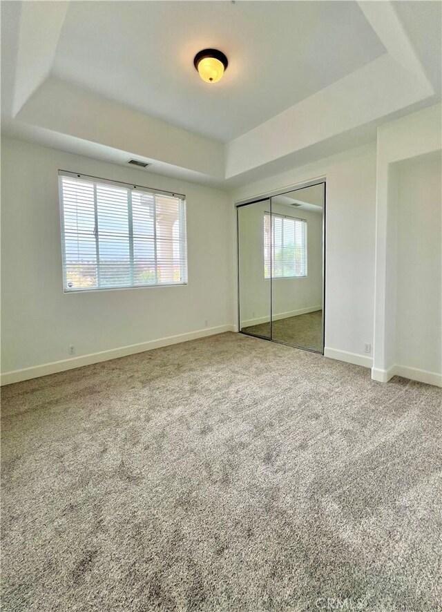 4462 Fallsbrae Rd, Fallbrook, CA 92028 - unfurnished bedroom featuring a tray ceiling, multiple windows, and baseboards