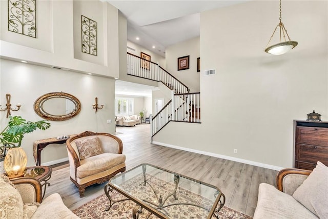 2517 Macbeth Ave, Corona, CA 92882 - living area featuring wood finished floors, stairway, a towering ceiling, baseboards, and recessed lighting