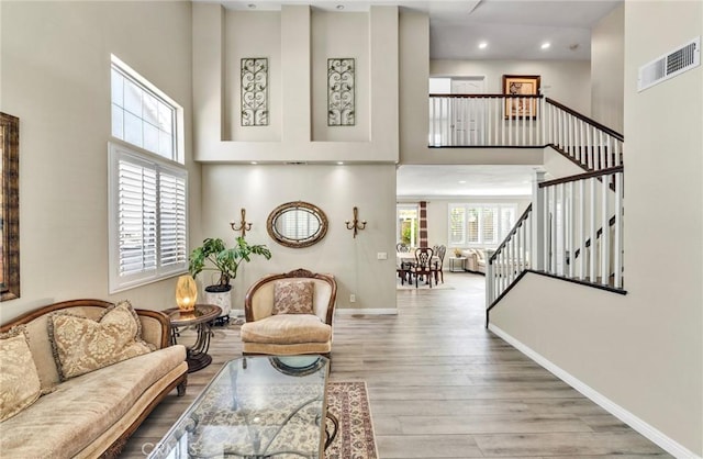 2517 Macbeth Ave, Corona, CA 92882 - living room featuring a high ceiling, wood finished floors, stairs, baseboards, and recessed lighting