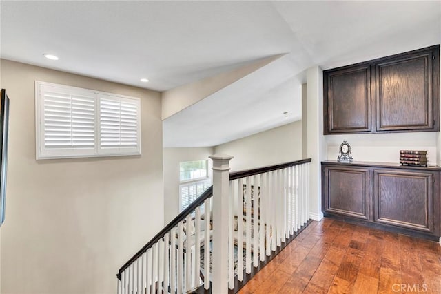 2517 Macbeth Ave, Corona, CA 92882 - hallway featuring dark wood-style floors, recessed lighting, baseboards, and an upstairs landing
