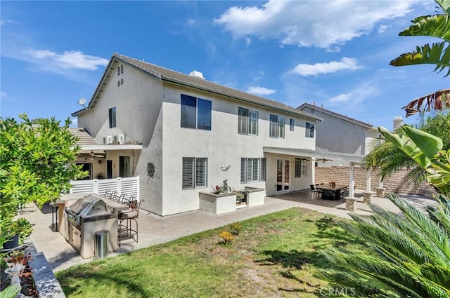 2517 Macbeth Ave, Corona, CA 92882 - back of house with a fire pit, ceiling fan, stucco siding, and exterior kitchen