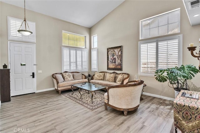 2517 Macbeth Ave, Corona, CA 92882 - living area featuring light wood-style floors, baseboards, and high vaulted ceiling
