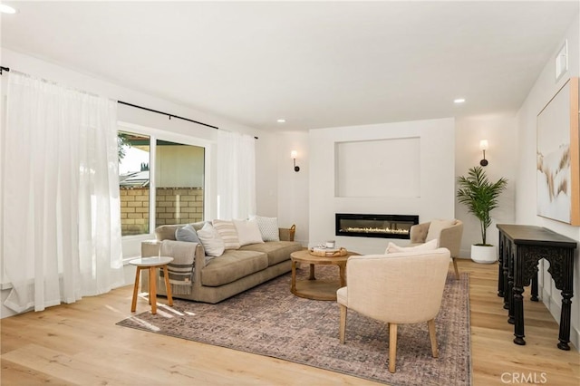 5662 Trail View Pl, Yorba Linda, CA 92886 - living room with light wood-type flooring, a glass covered fireplace, and recessed lighting