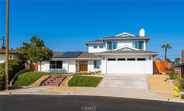 5662 Trail View Pl, Yorba Linda, CA 92886 - view of front of property featuring solar panels, driveway, stucco siding, and a chimney