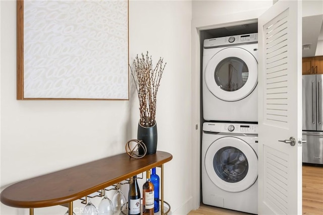 5662 Trail View Pl, Yorba Linda, CA 92886 - laundry area featuring estacked washer and dryer and light wood-style floors