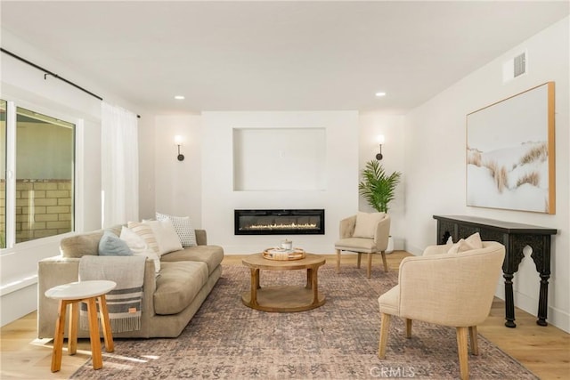 5662 Trail View Pl, Yorba Linda, CA 92886 - living room featuring wood finished floors, a glass covered fireplace, and recessed lighting