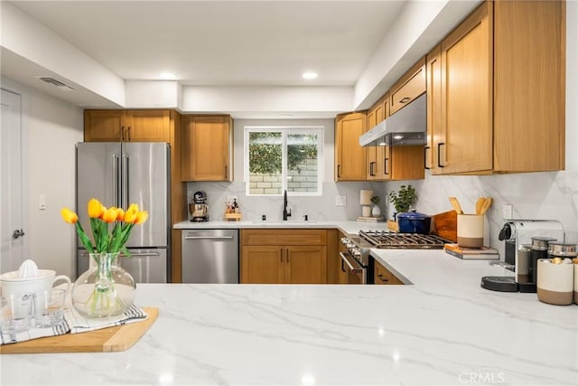5662 Trail View Pl, Yorba Linda, CA 92886 - kitchen with appliances with stainless steel finishes, a sink, under cabinet range hood, tasteful backsplash, and light stone counters