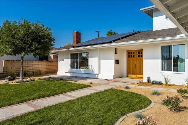 5662 Trail View Pl, Yorba Linda, CA 92886 - view of front of property featuring a chimney, roof mounted solar panels, and stucco siding