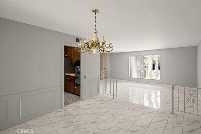 1403 W Westmont Dr, Anaheim, CA 92801 - empty room featuring light marble finish floors and a chandelier