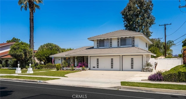 1403 W Westmont Dr, Anaheim, CA 92801 - view of front facade with driveway, an attached garage, a tiled roof, and stucco siding