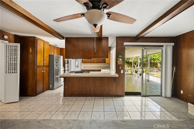 1403 W Westmont Dr, Anaheim, CA 92801 - kitchen with appliances with stainless steel finishes, beamed ceiling, wooden walls, a ceiling fan, and light countertops