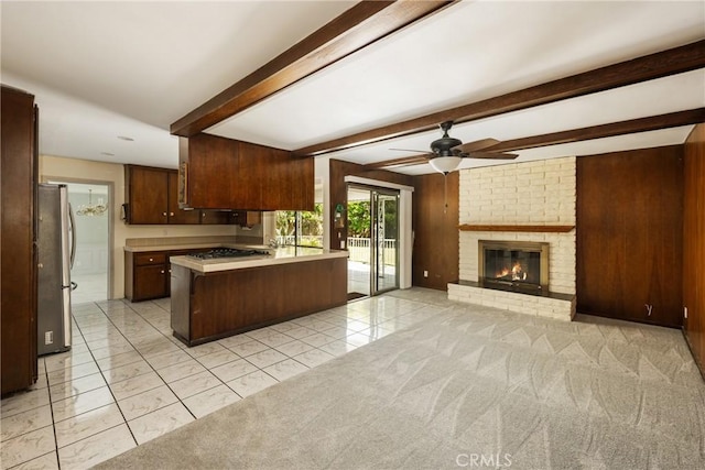1403 W Westmont Dr, Anaheim, CA 92801 - kitchen with open floor plan, freestanding refrigerator, ceiling fan, light countertops, and a peninsula