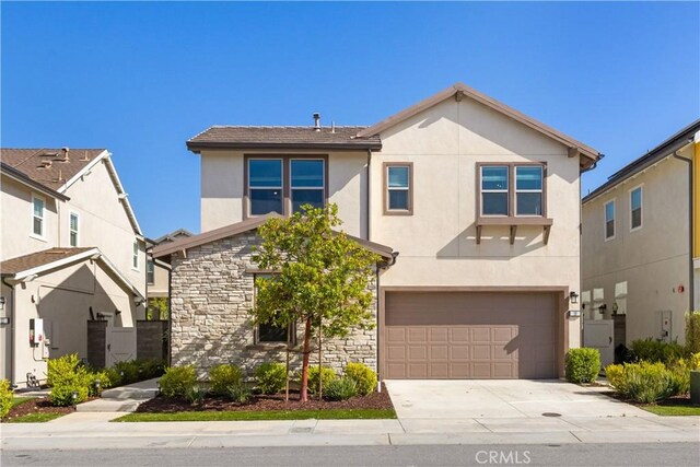 10 Veraz Rd, Rancho Mission Viejo, CA 92694 - traditional home with stone siding, stucco siding, a garage, and concrete driveway
